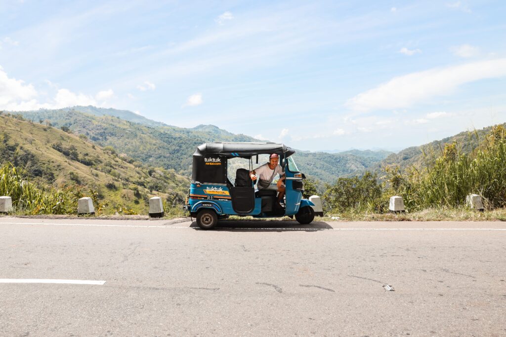 Scenic pause Tuktuk enjoys the stunning mountain panorama along Ella to Wellawaya road, a moment of pure tranquility