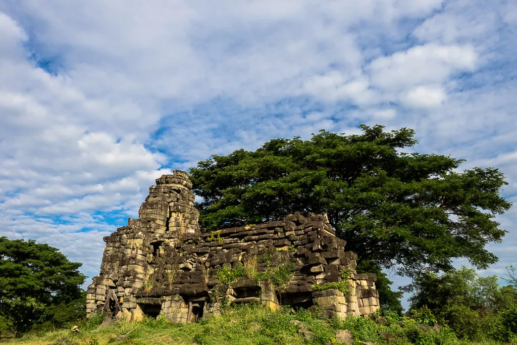 Ancient stone temple ruins under blue sky.