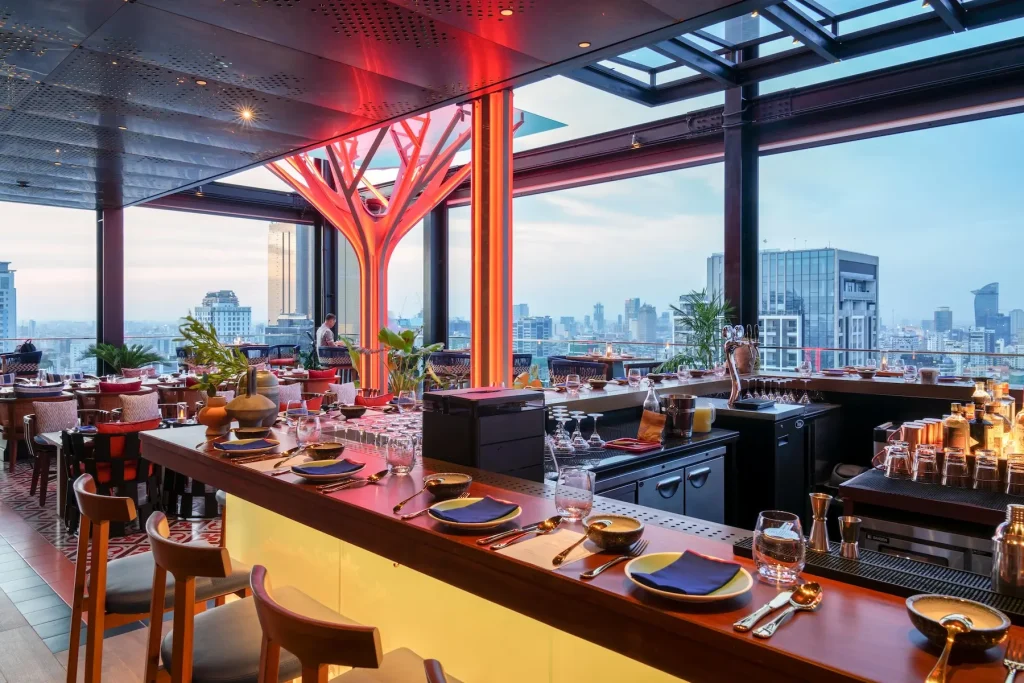 Modern rooftop bar overlooking city skyline.