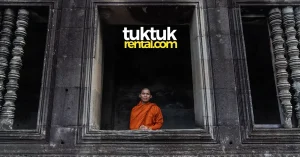 Buddhist monk standing in ancient temple window.