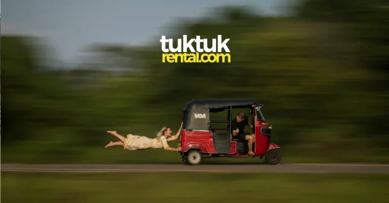 an image of a female tourist hanging on to a moving tuktuk from the back while a male tourist drives the tuktuk