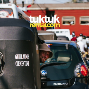 Men peeking out of a tuk-tuk