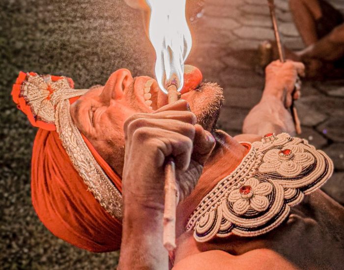 A man with an open mouth and fire on.