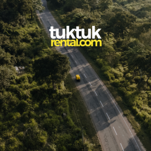 A drone shot of a tuk-tuk in motion.