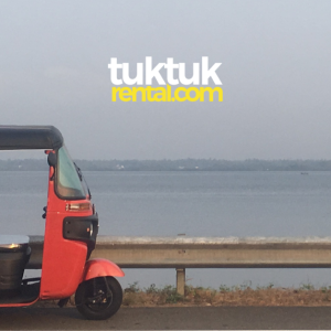 A red tuk-tuk is parked in the corner, with a logo visible.